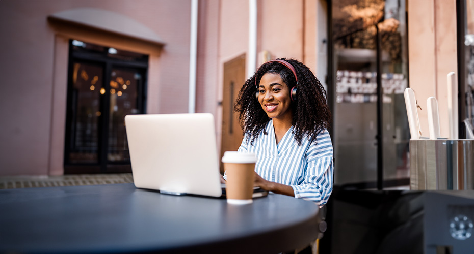 Woman sat at a desk using a laptop