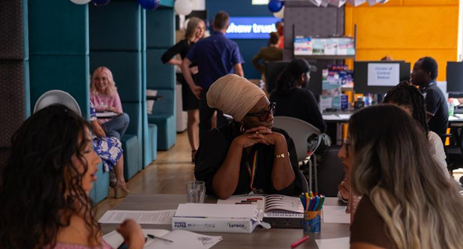 Group of people sitting around a table at an event.