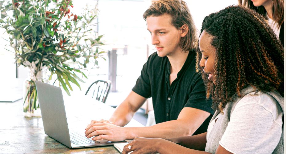 Two people sat at a laptop